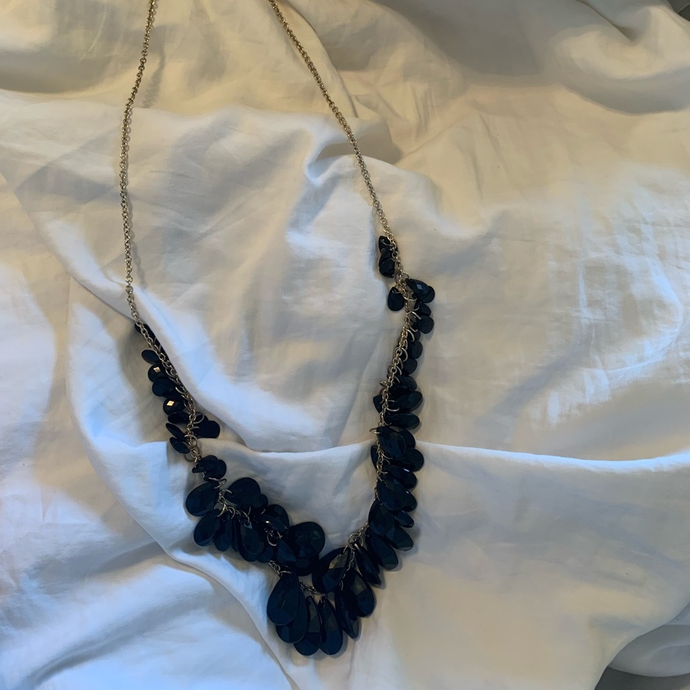 Black with gold colored chain. This necklace is long.